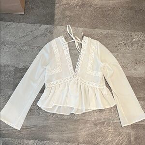 Sheer white v-neck blouse with lace detail
